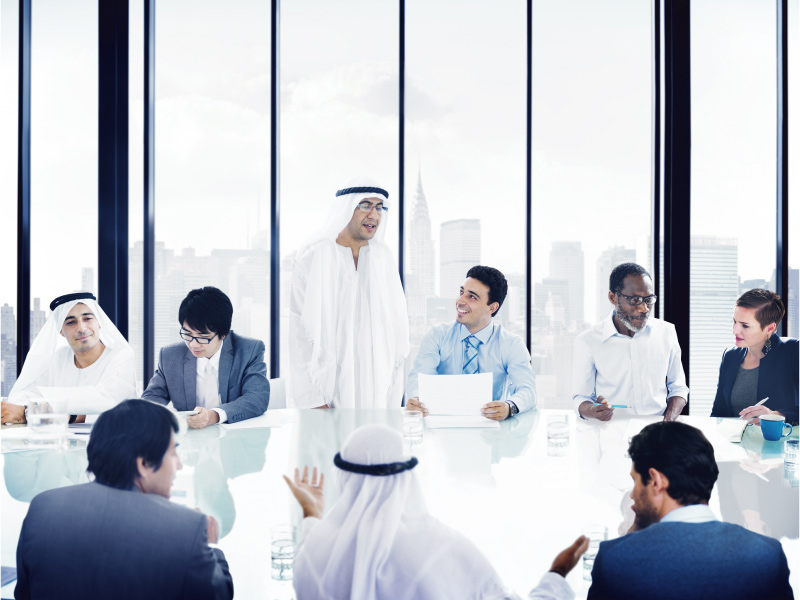 Diverse group of Arab business professionals discussing in a meeting room.